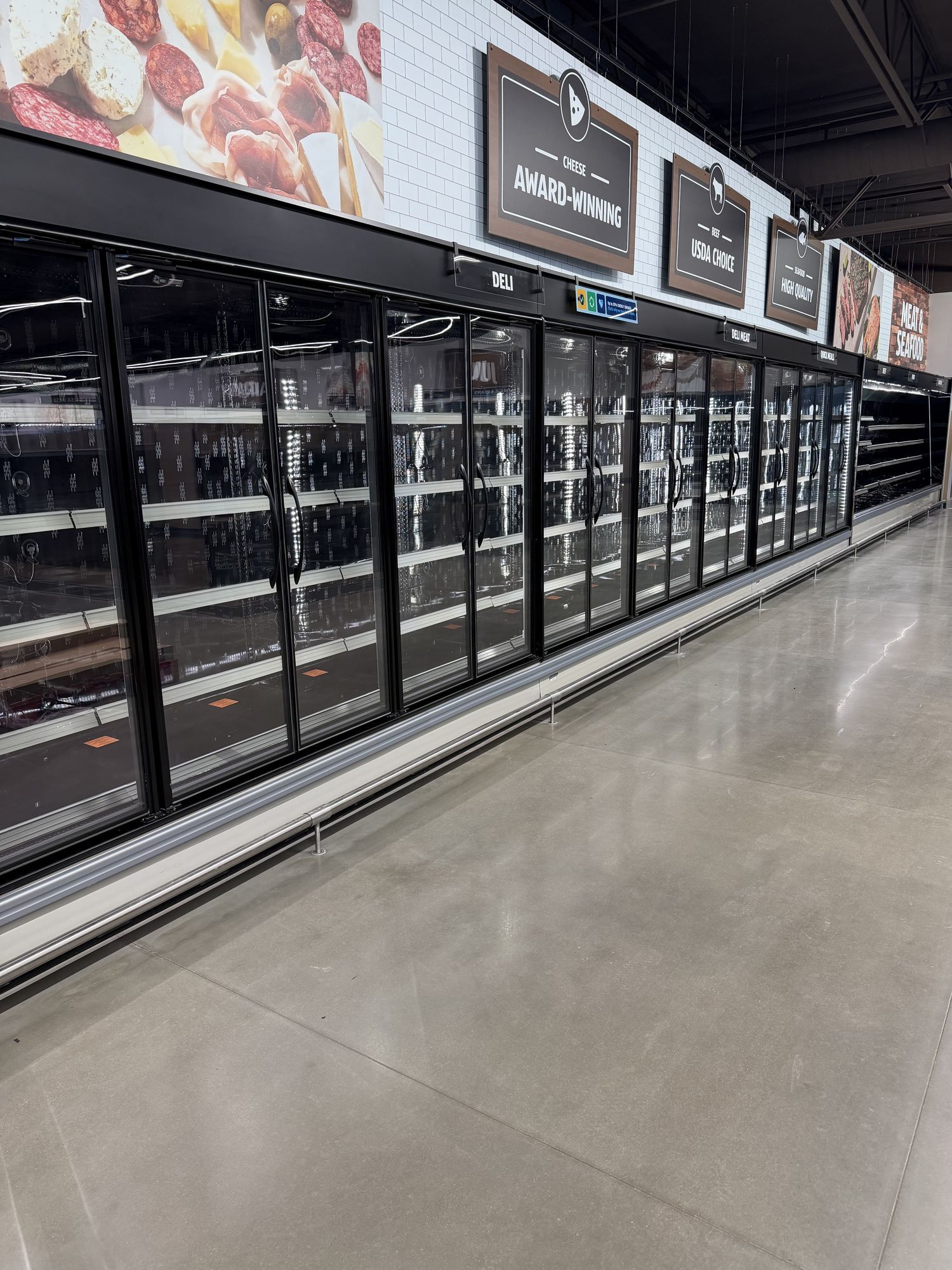 Glass cooler doors and polished concrete floor, cleaned for opening